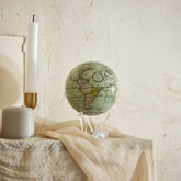 Antique Cassini Green MOVA Globe displayed on console table home decor