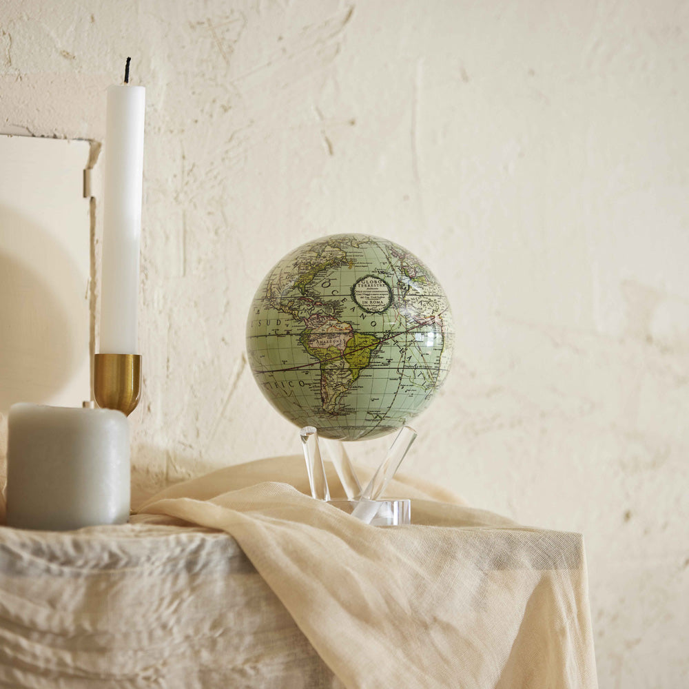 Antique Cassini Green MOVA Globe displayed on console table home decor