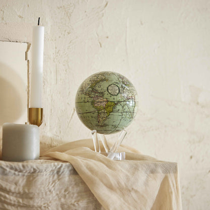 Antique Cassini Green MOVA Globe displayed on console table home decor