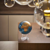 Cerulean Blue & Gold MOVA Globe on acrylic base in modern interior