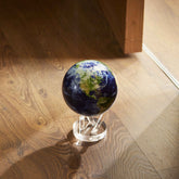 Earth with Clouds MOVA Globe displayed on hardwood floor with acrylic base