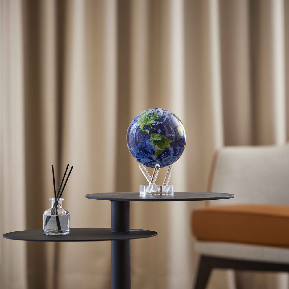 arth with Clouds MOVA Globe on modern side table with reed diffuser