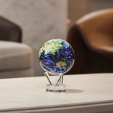 Earth with Clouds MOVA Globe displayed on coffee table with acrylic base