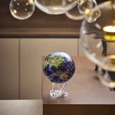 Earth with Clouds MOVA Globe displayed on countertop with glass decor